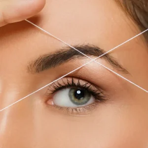 Eyebrow threading shaping natural brows with precision thread technique.