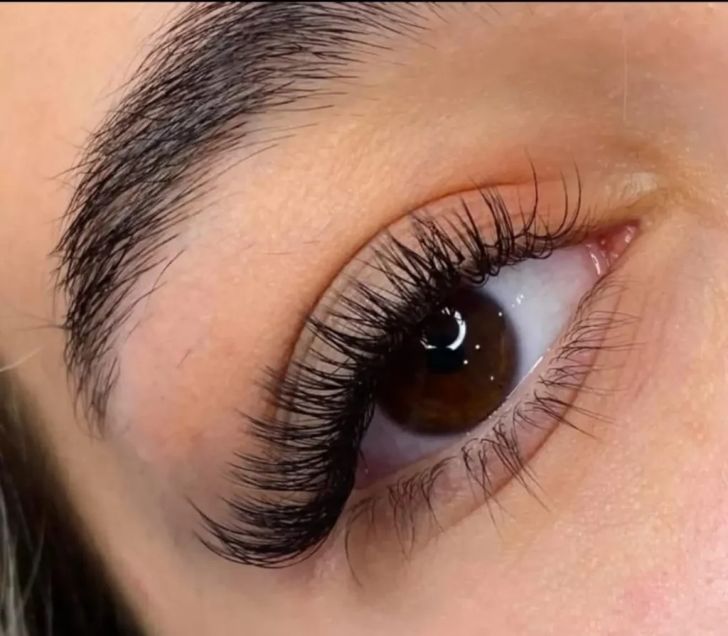 Natural-looking volume eyelash extensions on brown eyes at our beauty salon.