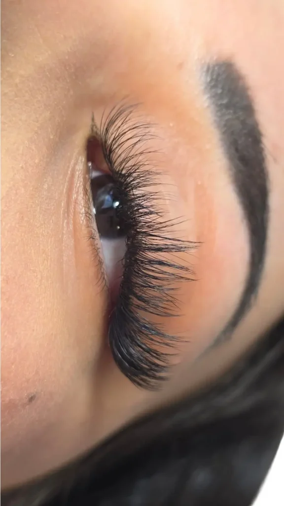 Wispy volume eyelash extensions with lifted curl and natural density, completed at Lashes Beauty Salon